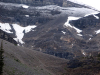 Up snow on left to wall then trail on scree/snow up to col.(pic from diff day)