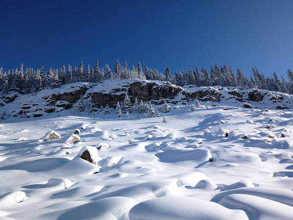 By Simpson Pass - looking up at cliffs and boulder field Note this split rock outcrop.Steeper than it looks - need skins